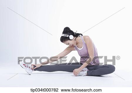 Stock Image - A woman stretching her leg. Fotosearch