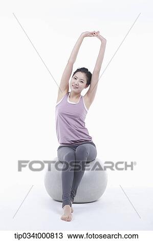 A woman stretching on a gym ball View Large Photo Image Stock Image - A woman stretching on a gym ball. Fotosearch