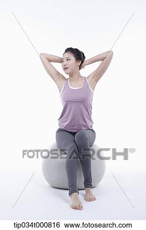 A woman stretching on a gym ball View Large Photo Image Stock Photograph - A woman stretching on a gym ball. Fotosearch