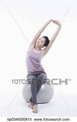 A woman stretching on a gym ball View Large Photo Image Stock Photography - A woman stretching on a gym ball. Fotosearch