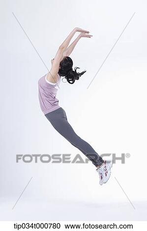 Stock Image - A woman stretching the whole body. Fotosearch