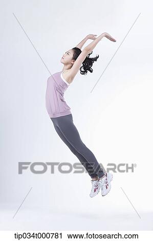 Stock Image - A woman stretching the whole body. Fotosearch