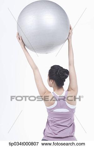 A woman stretching with a gym ball View Large Photo Image Stock Photo - A woman stretching with a gym ball. Fotosearch