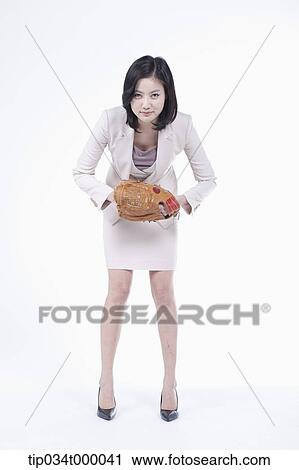 Stock Image - A woman wearing a baseball glove. Fotosearch