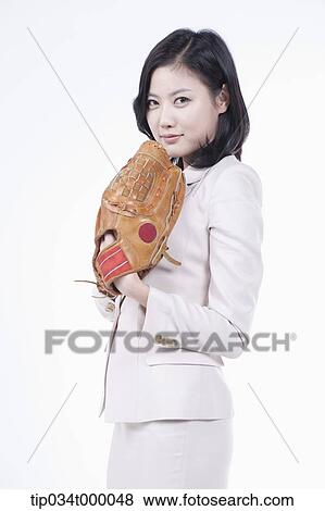 Stock Photo - A woman wearing a baseball glove. Fotosearch