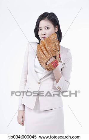 Stock Photography - A woman wearing a baseball glove. Fotosearch