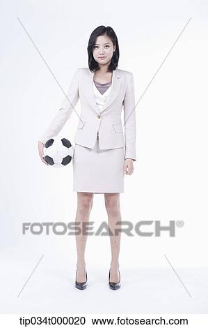 Stock Image - A woman with soccer ball . Fotosearch