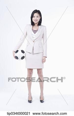 Stock Image - A woman with soccer ball . Fotosearch