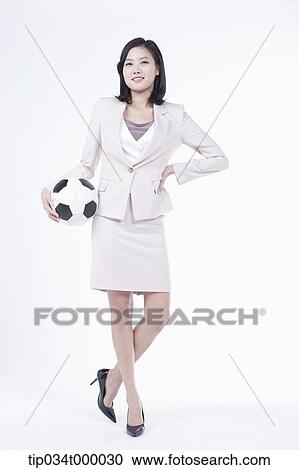 Stock Image - A woman with soccer ball . Fotosearch