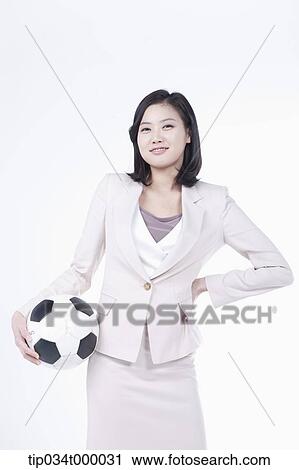 Stock Image - A woman with soccer ball . Fotosearch