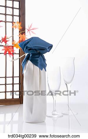 Stock Photo - A wrapped bottles with cloth and glasses. Fotosearch