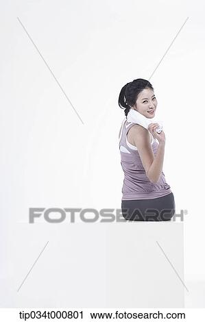 Stock Image - An excersing woman with a towel. Fotosearch