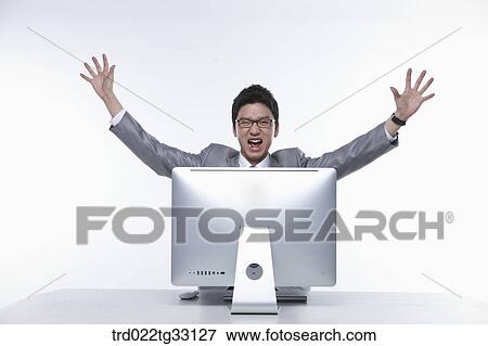 Stock Photo - An excited businessman in front of the monitor. Fotosearch
