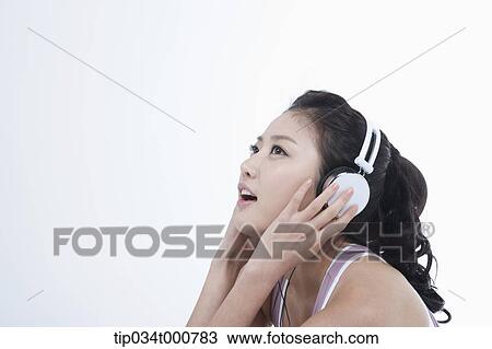 An exercising woman taking a break with music View Large Photo Image Stock Image - An exercising woman taking a break with music. Fotosearch