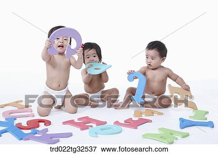 Stock Photo - Babies playing with alphabet blocks. Fotosearch