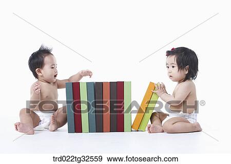 Babies sitting around the books View Large Photo Image Stock Photo - Babies sitting around the books. Fotosearch