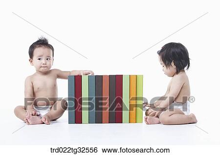 Babies sitting around the books View Large Photo Image Stock Photograph - Babies sitting around the books. Fotosearch