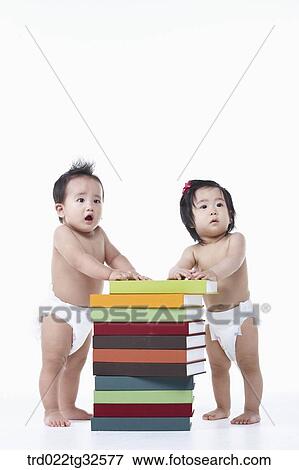 Babies standing up around the books View Large Photo Image Stock Photo - Babies standing up around the books. Fotosearch