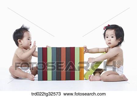 Babies touching on the books View Large Photo Image Stock Image - Babies touching on the books. Fotosearch