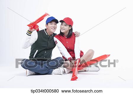 Stock Image - Baseball supporters with cheering tools. Fotosearch