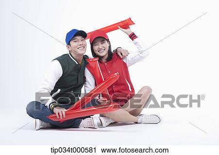 Stock Image - Baseball supporters with cheering tools. Fotosearch