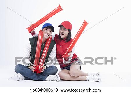 Stock Photo - Baseball supporters with cheering tools. Fotosearch