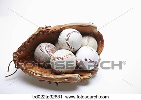 Stock Image - Baseballs in a glove. Fotosearch