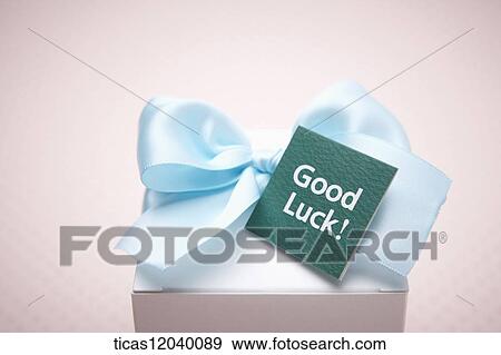 Stock Photo - Blue ribbon gift box and good luck card. Fotosearch