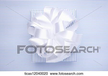 Stock Image - Blue stripe gift box with white ribbon . Fotosearch
