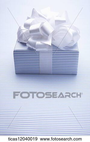 Stock Photo - Blue stripe gift box with white ribbon . Fotosearch