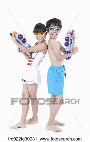 boy and girl are standing back to back with water guns View Large Photo Image Stock Image - boy and girl are standing back to back with water guns. Fotosearch