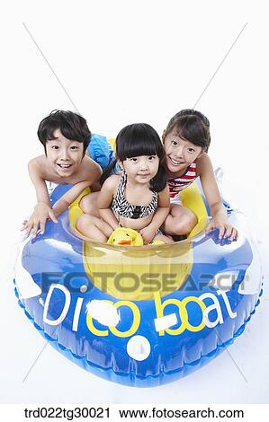 Stock Image - boy and girls are on the boat. Fotosearch