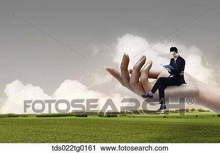 business man is sitting on the hand View Large Photo Image Stock Image - business man is sitting on the hand. Fotosearch