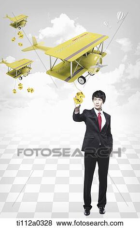 Businessman holding the dollar from the credit card planes View Large Photo Image Stock Photo - Businessman holding the dollar from the credit card planes. Fotosearch