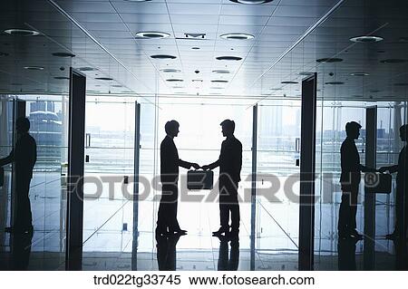 Businessmen handing over the briefcase in the hallway View Large Photo Image Stock Photography - Businessmen handing over the briefcase in the hallway. Fotosearch