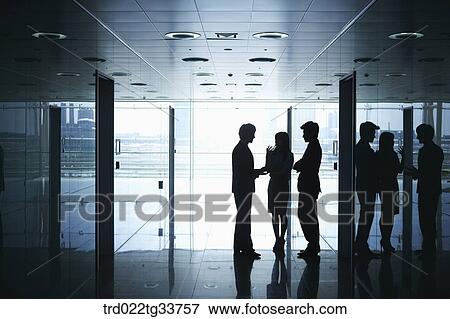 Stock Photo - Businessmen having discussion in the hallway. Fotosearch