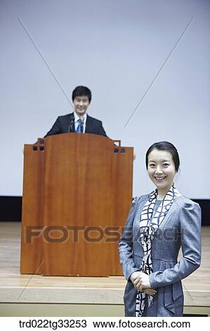Stock Image - Businessmen having presentation in the auditorium. Fotosearch