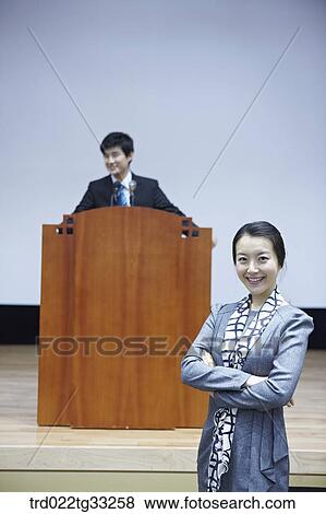 Stock Photo - Businessmen having presentation in the auditorium. Fotosearch