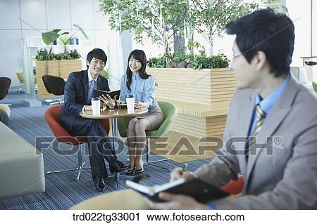 Stock Image - Businessmen holding the planner in the lounge. Fotosearch