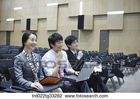 Businessmen listening to the seminar in the auditorium View Large Photo Image Stock Image - Businessmen listening to the seminar in the auditorium. Fotosearch