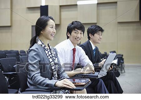 Businessmen listening to the seminar in the auditorium View Large Photo Image Stock Photo - Businessmen listening to the seminar in the auditorium. Fotosearch