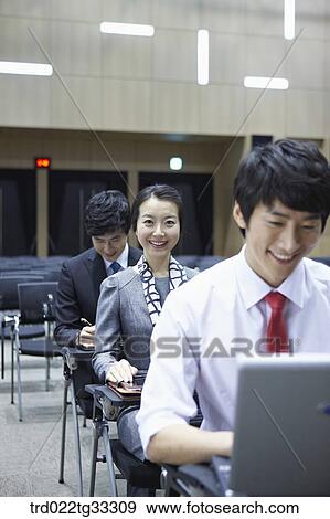 Businessmen listening to the seminar in the auditorium View Large Photo Image Stock Photo - Businessmen listening to the seminar in the auditorium. Fotosearch