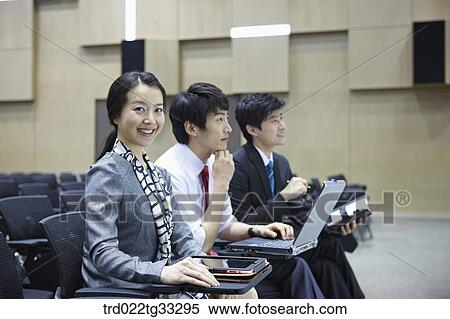 Stock Photography - Businessmen listening to the seminar in the auditorium. Fotosearch