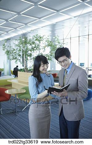 Businessmen looking at the planner View Large Photo Image Stock Photo - Businessmen looking at the planner . Fotosearch