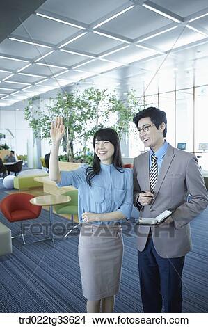 Picture - Businessmen saying hello to someone. Fotosearch