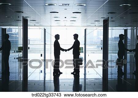 Businessmen shaking hands in the hallway View Large Photo Image Stock Image - Businessmen shaking hands in the hallway. Fotosearch