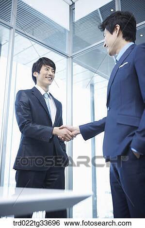 Businessmen shaking hands together View Large Photo Image Stock Photograph - Businessmen shaking hands together. Fotosearch