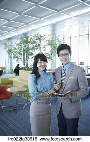Businessmen smiling with the planner View Large Photo Image Stock Photograph - Businessmen smiling with the planner. Fotosearch