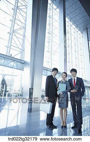 Businessmen standing in the lobby View Large Photo Image Stock Photo - Businessmen standing in the lobby . Fotosearch