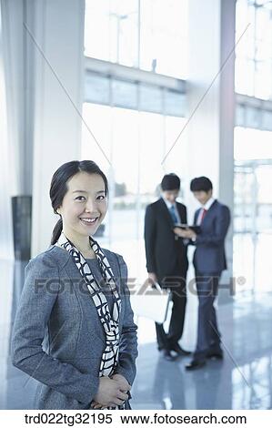 Stock Photography - Businessmen standing in the lobby . Fotosearch